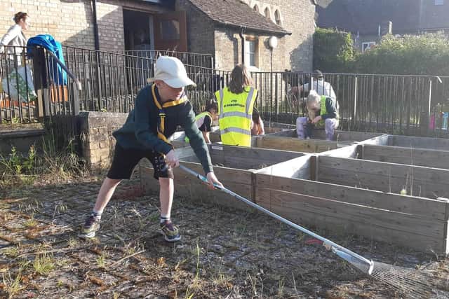 Jacob Dickinson, 8, was one of around 30 scouts helping to get Thorney and Eye Foodbank's garden ship-shape.
