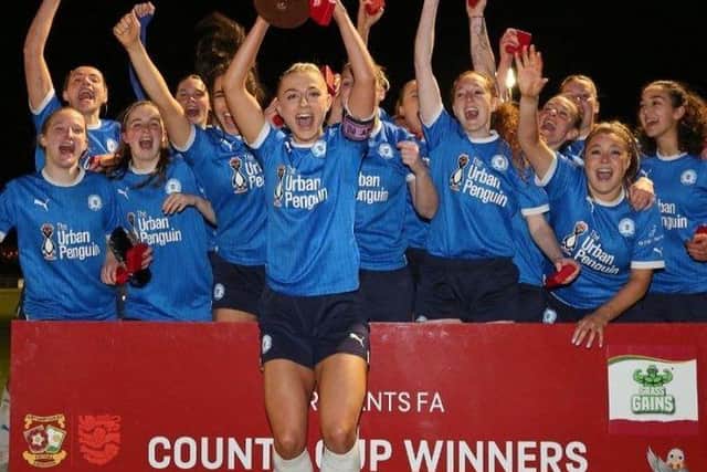 Posh skipper Keir Perkins holds the Northants County Womens Cup aloft in front of delighted teammates. Photo: Joe Dent/theposh.com.