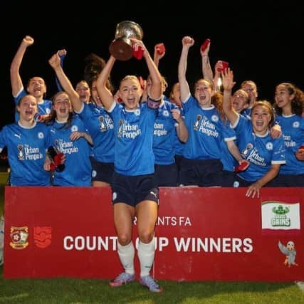 Posh skipper Keir Perkins holds the Northants County Womens Cup aloft in front of delighted teammates. Photo: Joe Dent/theposh.com.
