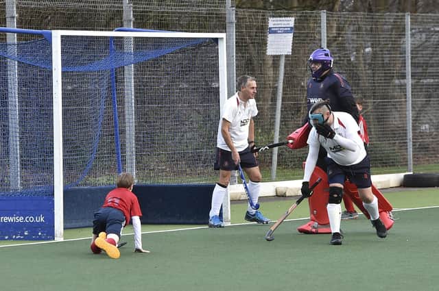 Action from City of Peterborough 7ths (red) v Wisbech 4ths. Photo: David Lowndes.