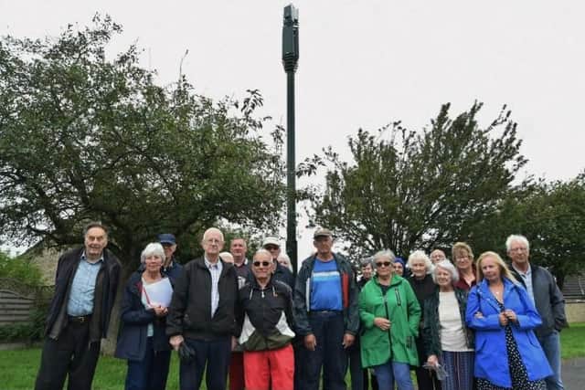 Around 20 residents of Ennerdale Rise met near an existent pole on a grass verge at the end of their road to show their collective objection to more being built in the area