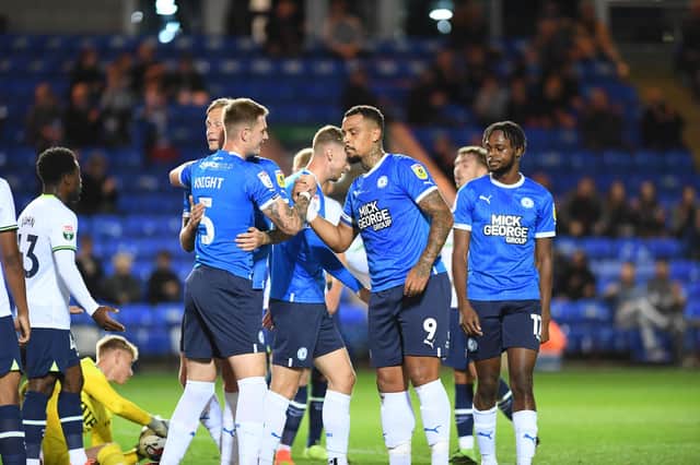 Josh Knight (left) is congratulated after opening the scoring for Posh against Spurs. Photo: David Lowndes.