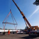 One of the two giant supports being lowered into place for welding