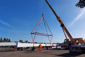 One of the two giant supports being lowered into place for welding