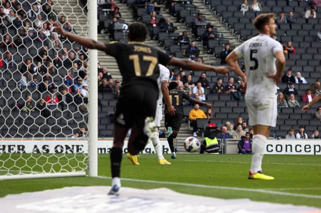 Kwame Poku of Peterborough United wheels away after scoring his goal against Milton Keynes. Photo: Joe Dent.