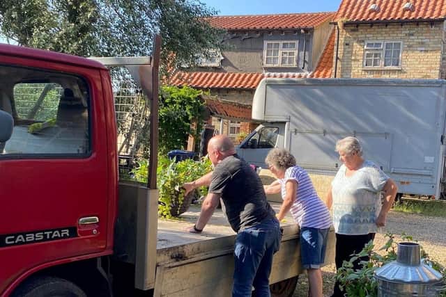 Residents of Chatteris in Bloom putting up their floral displays.