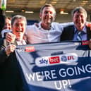Posh co-owners Stewart Thompson, Darragh MacAnthony and Jason Neale celebrate winning promotion from League One last season. Photo: Joe Dent/theposh.com.