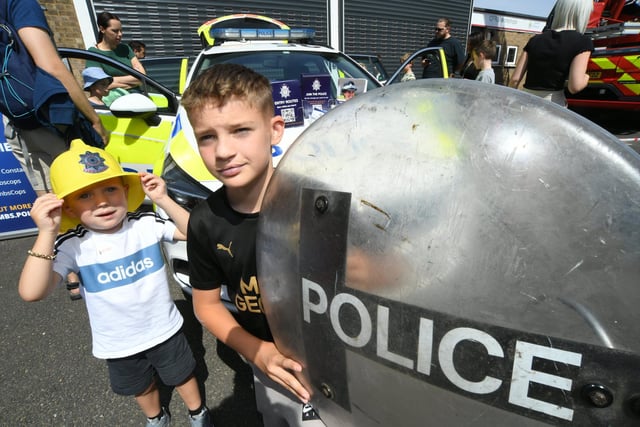 Radleigh Franklin and Ethan Murray looking at the police equipment.