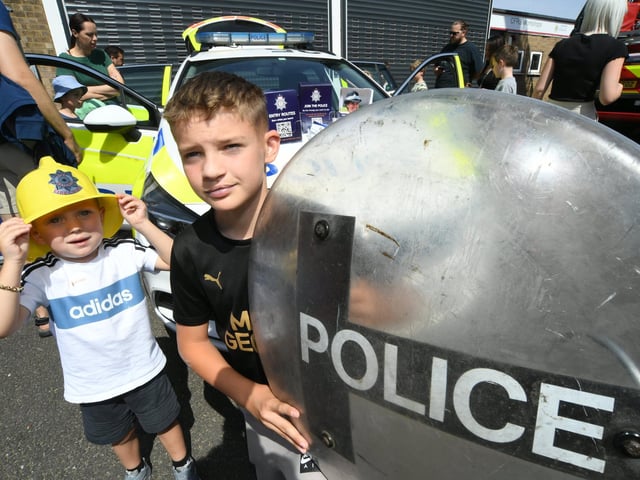 Radleigh Franklin and Ethan Murray looking at the police equipment.