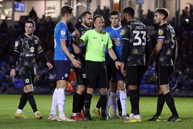 MK players take issue with referee David Rock's decision to award Posh a penalty in the second half. Photo: Joe Dent.