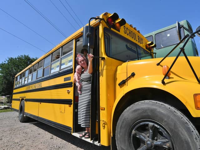 Charlotte Scriven and baby Alistair with their US school bus.