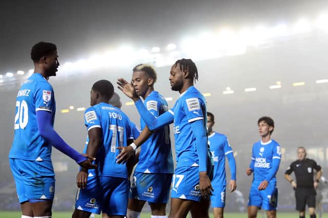 Ricky-Jade Jones of Peterborough United is congratulated by Emmanuel Fernandez and teammates after his goal against Spurs. Photo: Joe Dent/theposh.com.