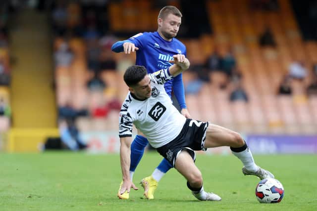 Alfie May (blue) is Cheltenham's dangerman. Photo by Morgan Harlow/Getty Images.