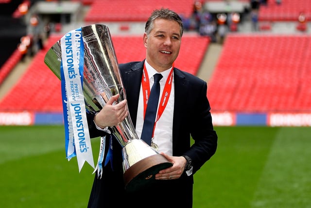 Peterborough manager Darren Ferguson celebrates with the trophy after watching his side get the better of Chesterfield in the Johnstone's Paint Trophy final.