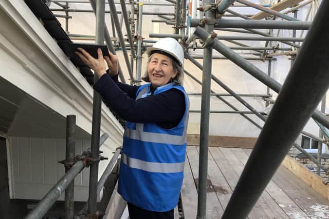 Lea Rickard, Stamford Library’s manager, repairing the roof.