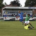 Ayman Trabelsi (green) in action for FC Peterborough against Wivenhoe. Photo: Tim Symonds