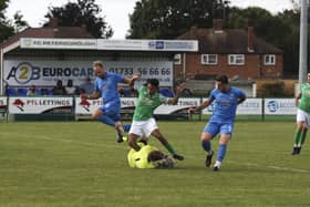 Ayman Trabelsi (green) in action for FC Peterborough against Wivenhoe. Photo: Tim Symonds