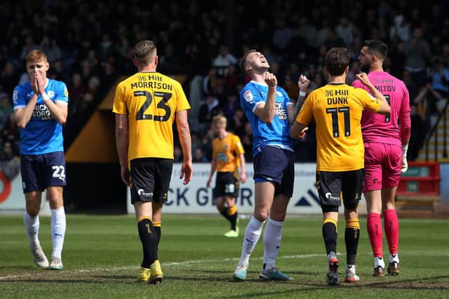 Woe for Jack Taylor after missing a great chance to score for Posh in the 2-0 defeat at Cambridge United. Photo: Joe Dent/theposh.com.