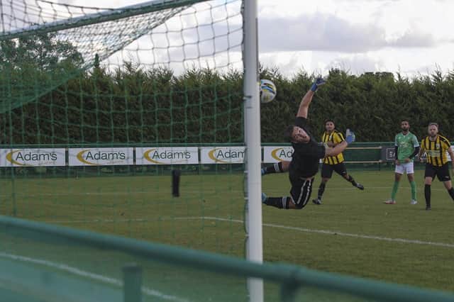 Hamza Akram (green) scores a superb goal for FC Peterborough against Crowland. Photo: Tim Symonds.