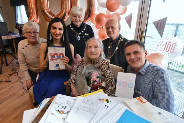 100-year-old Iris Taylor celebrates her birthday at Hampton Grove Care Home with singer Gabriella, Deputy Mayor Nick Sandford, Deputy Mayoress Bella Saltmarsh and staff Deb Day and Krzysztof Krzyszfofika