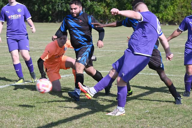 Sunday League action from Stanground Cardea Sports Development (purple) v Peterborough Saints. Photo David Lowndes.