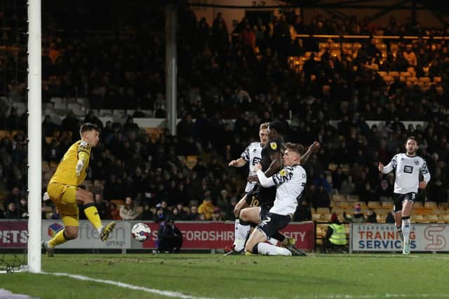 Port Vale defenders try to stop Ephron Mason-Clark scoring his second of the game. Photo: Joe Dent.