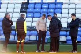Darren Ferguson and Dean Holden inspect the pitch before the match was called off: Photo: Joe Dent.