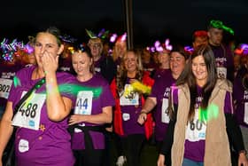 Walkers donned glow in the dark accessories and neon face paints as they set off from Ferry Meadows County Par. Photo: Matt Jeffery Photography