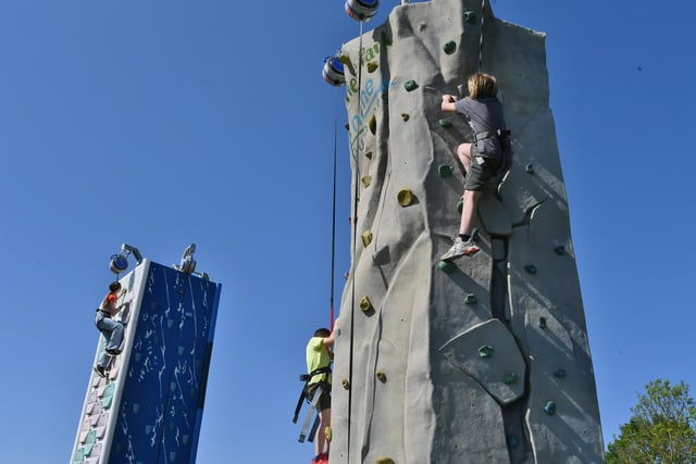 Attendees have a go on the climbing wall.