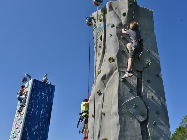 Attendees have a go on the climbing wall.