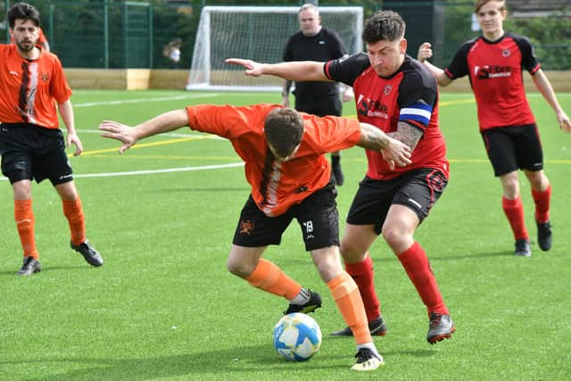 Action from Thorney's 4-0 win at Netherton A (red) at the Grange. Photo David Lowndes.
