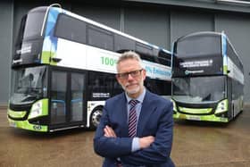 Darren Roe in front of two of Stagecoach East's electric buses