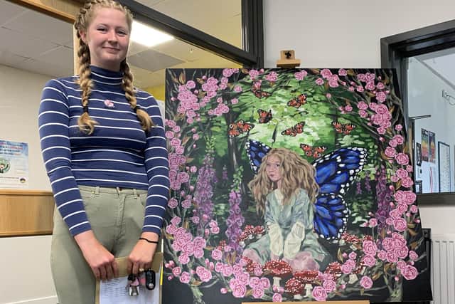 Emily Knight in front of a piece of her artwork.