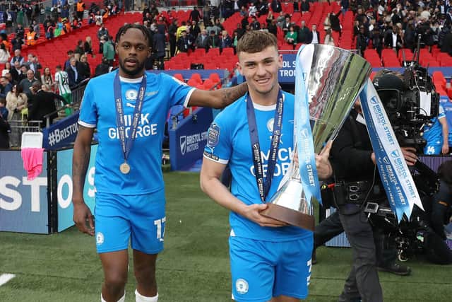 Posh skipper Harrison Burrows with the EFL Trophy. Joe Dent/theposh.com