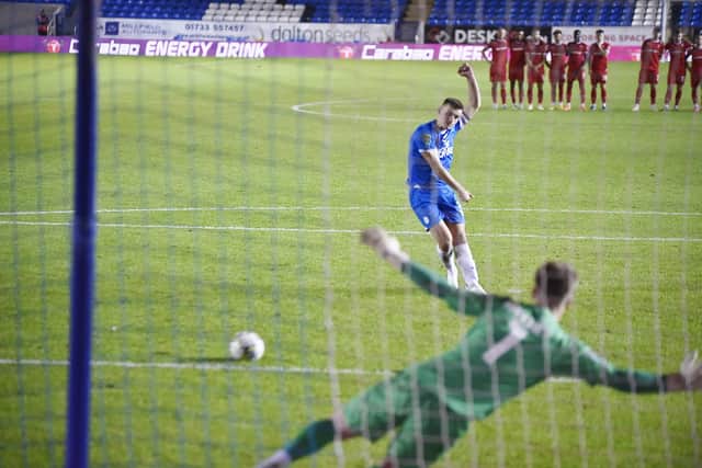 Harrison Burrows scores the winning penalty for Peterborough United against Swindon Town. Photo: David Lowndes.