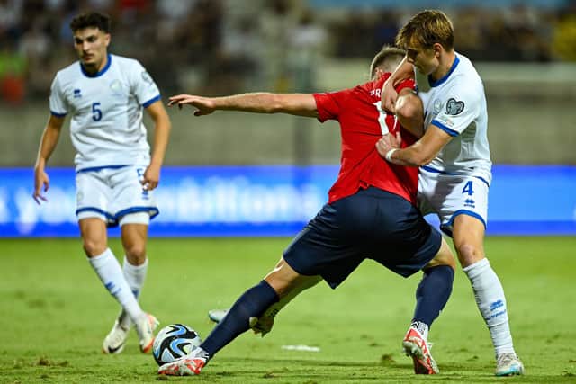 Hector Kyprianou (right) in action for Cyprus. Photo by Jewel Samad, AFP via Getty Images.