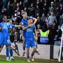 Posh celebrate Harry Leonard's second goal for Posh v Cobblers. Photo David Lowndes.
