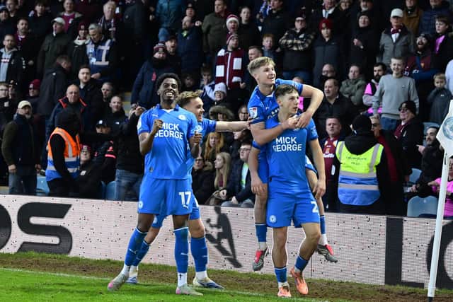 Posh celebrate Harry Leonard's second goal for Posh v Cobblers. Photo David Lowndes.