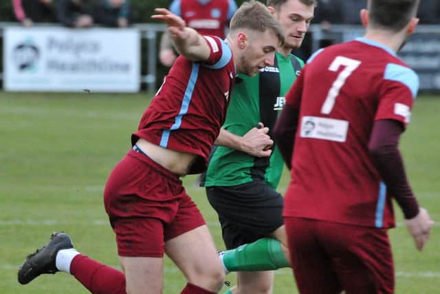 Robbie Ellis (left) of Bourne in action against Blackstones.