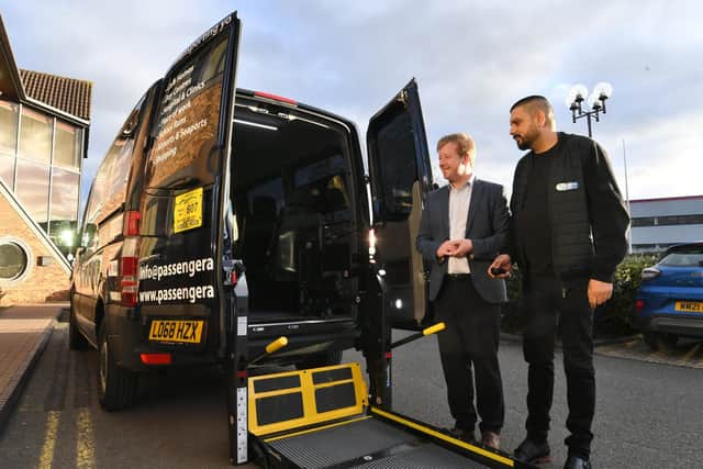 Mohammed Bashir, of Passenger Assist Cambridgeshire, shows his new tail-lift enabled vehicle to Peterborough MP Paul Bristow.
