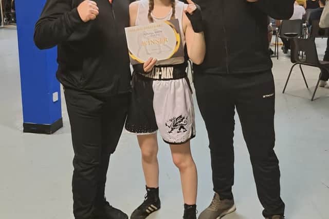Police Boxing Club head coach Chris Baker with Hannah May Anderson and coach Damien Stocks