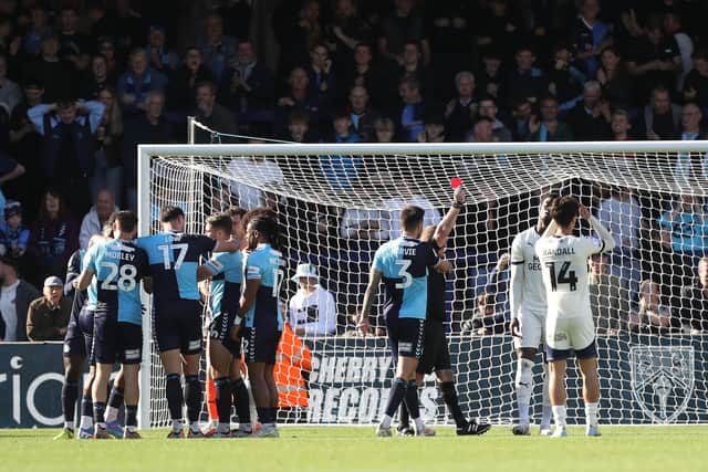 Emmanuel Fernandez is shown a red card following a handball. Photo: Joe Dent.