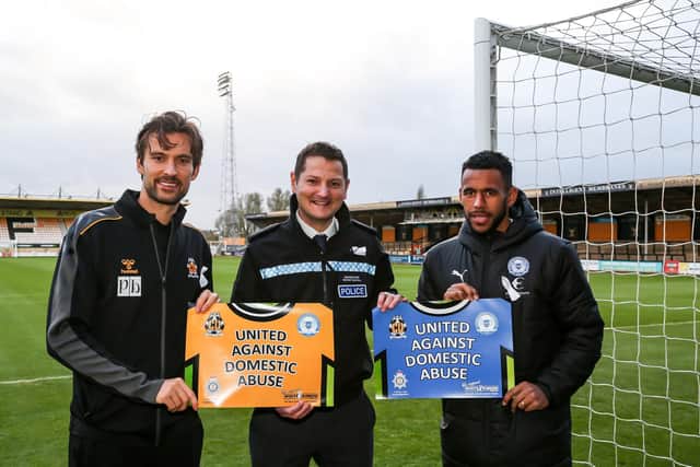 Peterborough United's Nathan Thompson shows his support for the campaign alongside Cambridge's Harrison Dunk and Det Insp David Savill. Photo: Joe Dent.