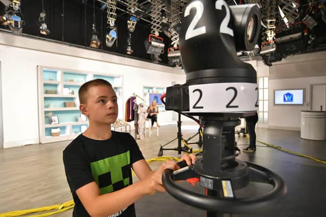 TV shopping enthusiast Joseph Race (12) takes a look through the cameras during a tour of Ideal World studios at Newark Road, Peterborough.