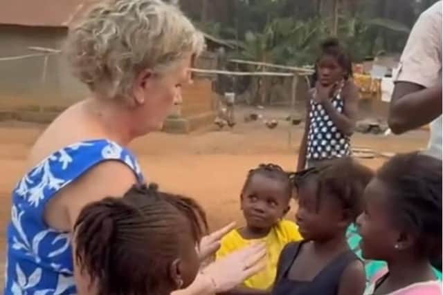 Lisa Kelly pictured with some of the local children in Sierra Leone.