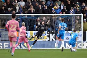 Fynn Talley of Peterborough United dives in vein as Patrick Bamford of Leeds United scores the second goal of the game. Photo: Joe Dent/theposh.com