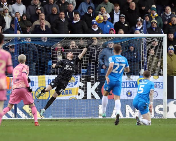 Fynn Talley of Peterborough United dives in vein as Patrick Bamford of Leeds United scores the second goal of the game. Photo: Joe Dent/theposh.com