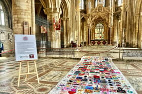 The impressive six-metre long Coronation quilt is made up of 320 unique squares of fabric contributed by people as far afield as Scotland.