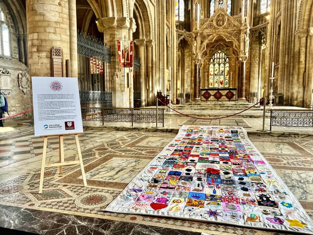 The impressive six-metre long Coronation quilt is made up of 320 unique squares of fabric contributed by people as far afield as Scotland.
