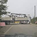 A lorry and trailer on a narrow road in Eye